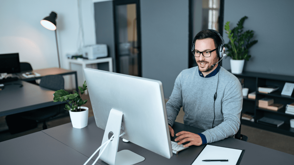 Guy at computer with headset